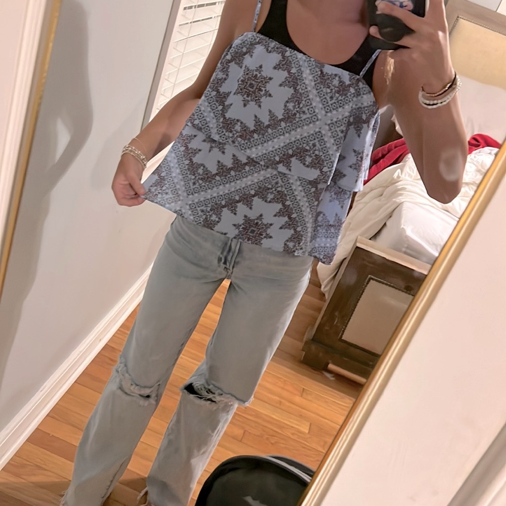 Super cute blue top with a red print on it